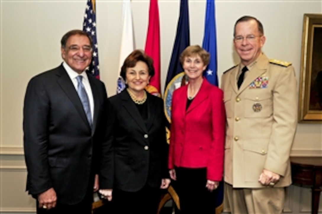 New Defense Secretary Leon E. Panetta, left, and his wife, Sylvia, host Navy Adm. Mike Mullen, chairman of the Joint Chiefs of Staff, right, and his wife, Deborah, in his office, July 1, 2011. 