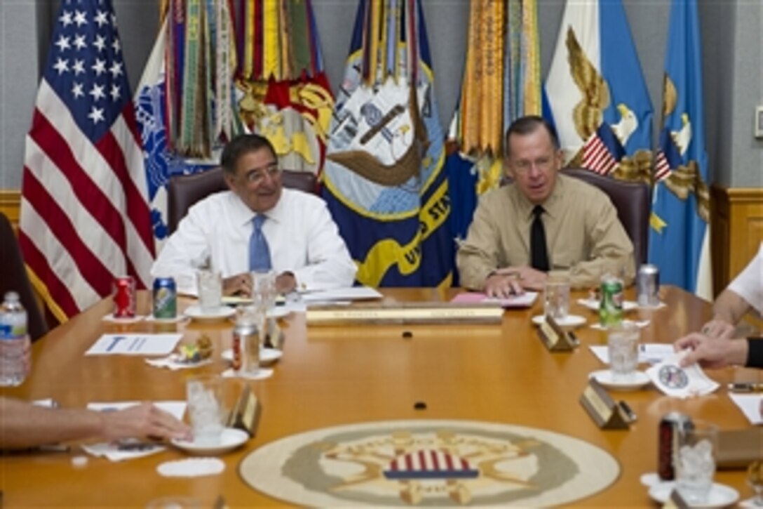 Chairman of the Joint Chiefs of Staff Adm. Mike Mullen speaks with new Secretary of Defense Leon E. Panetta during his first visit to the Tank to meet with the Joint Chiefs in the Pentagon on July 1, 2011.  