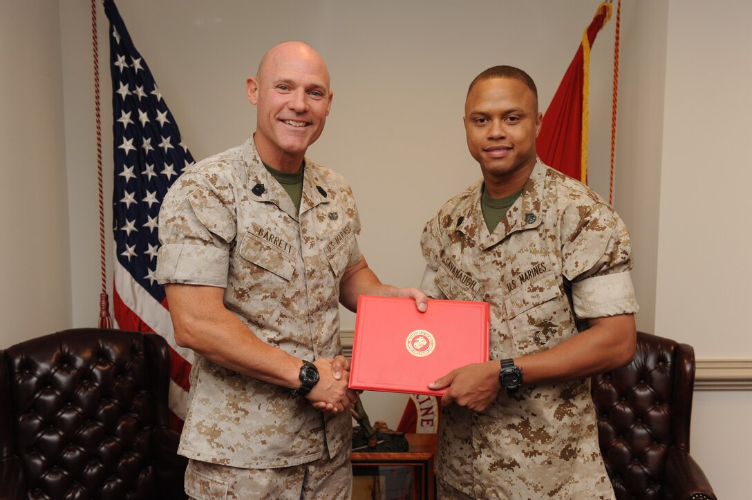 Sgt. Maj. Micheal P. Barrett, 17th Sergeant Major of the Marine Corps, meritoriously promotes Shawn Cavanaugh to the rank of staff sergeant in his office at the Pentagon, July 1, 2011.