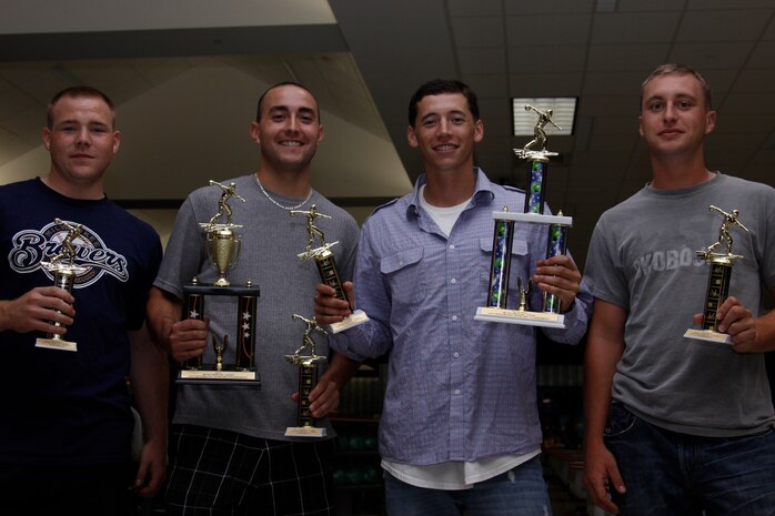 Darrin W. Sellers, Steven E. Reagan, Peter A. Lawson and Samuel L. Operle, Tiger’s Blood bowlers, pose for a photo with their trophies during the 2011 Bowling Tournament at The Strike Zone here Saturday. Reagan also won the most valuable player for the tournament.