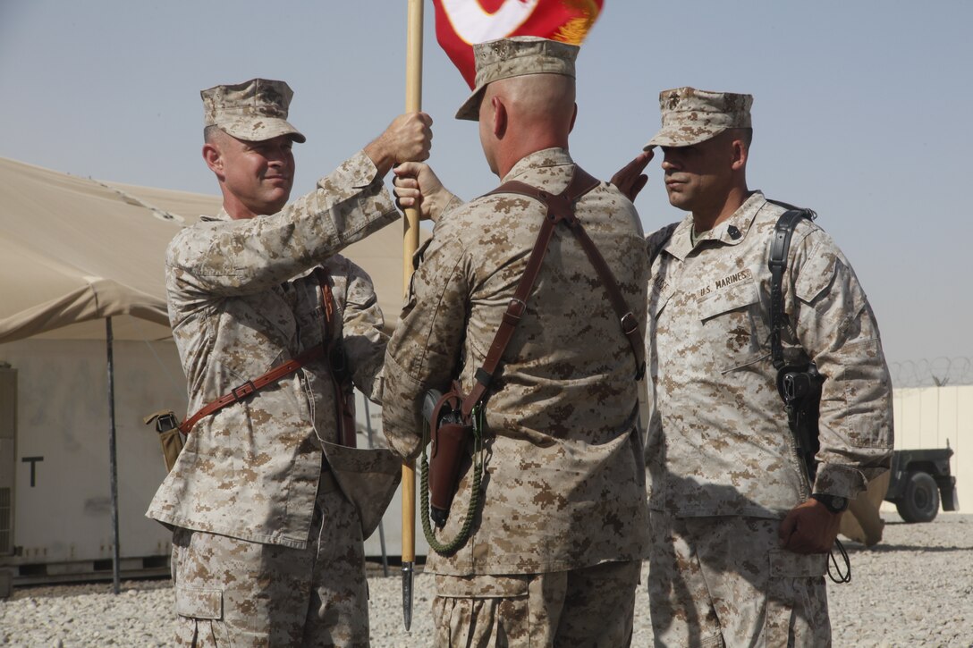 Lt. Col. Russell A Blauw accepts the squadron colors from Lt. Col Clarence T. Harper III becoming the new commanding officer of Marine Aviation Logistics Squadron 40, during a ceremony at Camp Bastion, Afghanistan, July 2. Harper, the squadron’s former commanding officer, is scheduled to attend the Industrial College of the Armed Forces in Washington D.C. following his relief.