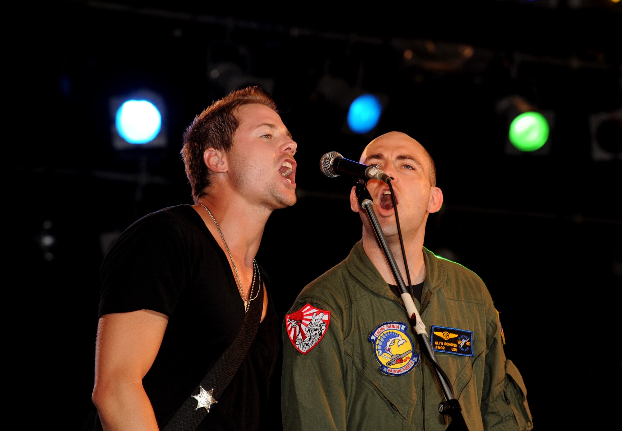 The back-up singer for Country/pop star Jessie James performs with a U.S service member during AmericaFest 2011 at Kadena Air Base, Japan, July 2. AmericaFest takes place July 1 and 2, and is an event designed to build international relations with the local Okinawan community. (U.S. Air Force photo/Airman 1st Class Jarvie Z. Wallace)