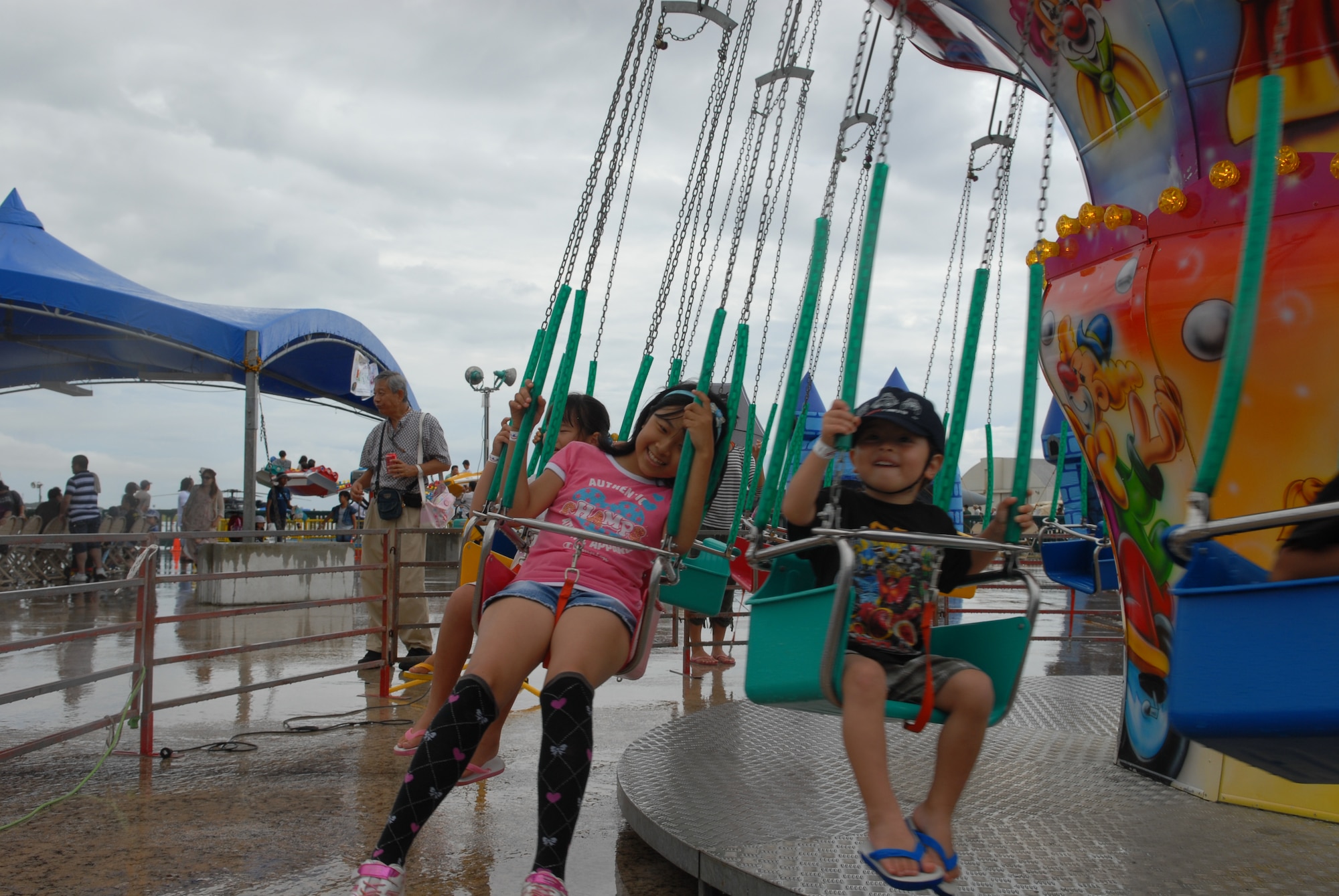 Children from the local community have fun on American amusement park rides during America Fest July 2, at Kadena Air Base, Japan. America Fest was held July 1 and 2 at on Kadena?s flight line to help celebrate July 4th. The event was open to all Status of Forces Agreement status ID holders and to all Japanese citizens July 2. The open house included musical guests, food and game booths and a wide variety of aircraft from the Air Force, Navy, Army, Marine Corps and Japan Air Self Defense Force as well. (U.S. Air Force photo/Senior Airman Sara Csurilla)