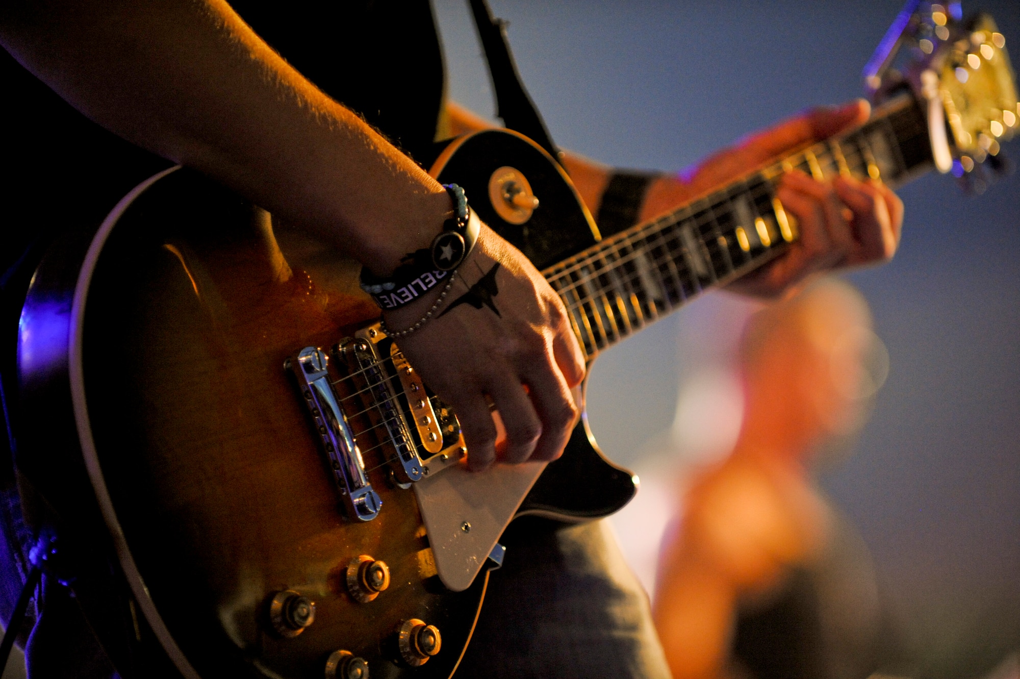 Guitarist for country singer Jessie James strums his electronic guitar at AmericaFest July 2. AmericaFest is a chance to celebrate Independence Day and share the celebration with our Japanese counterparts. Food, games and musical entertainment were also provided. (U.S.  Air Force Photo/Staff Sgt. Jonathan Steffen)