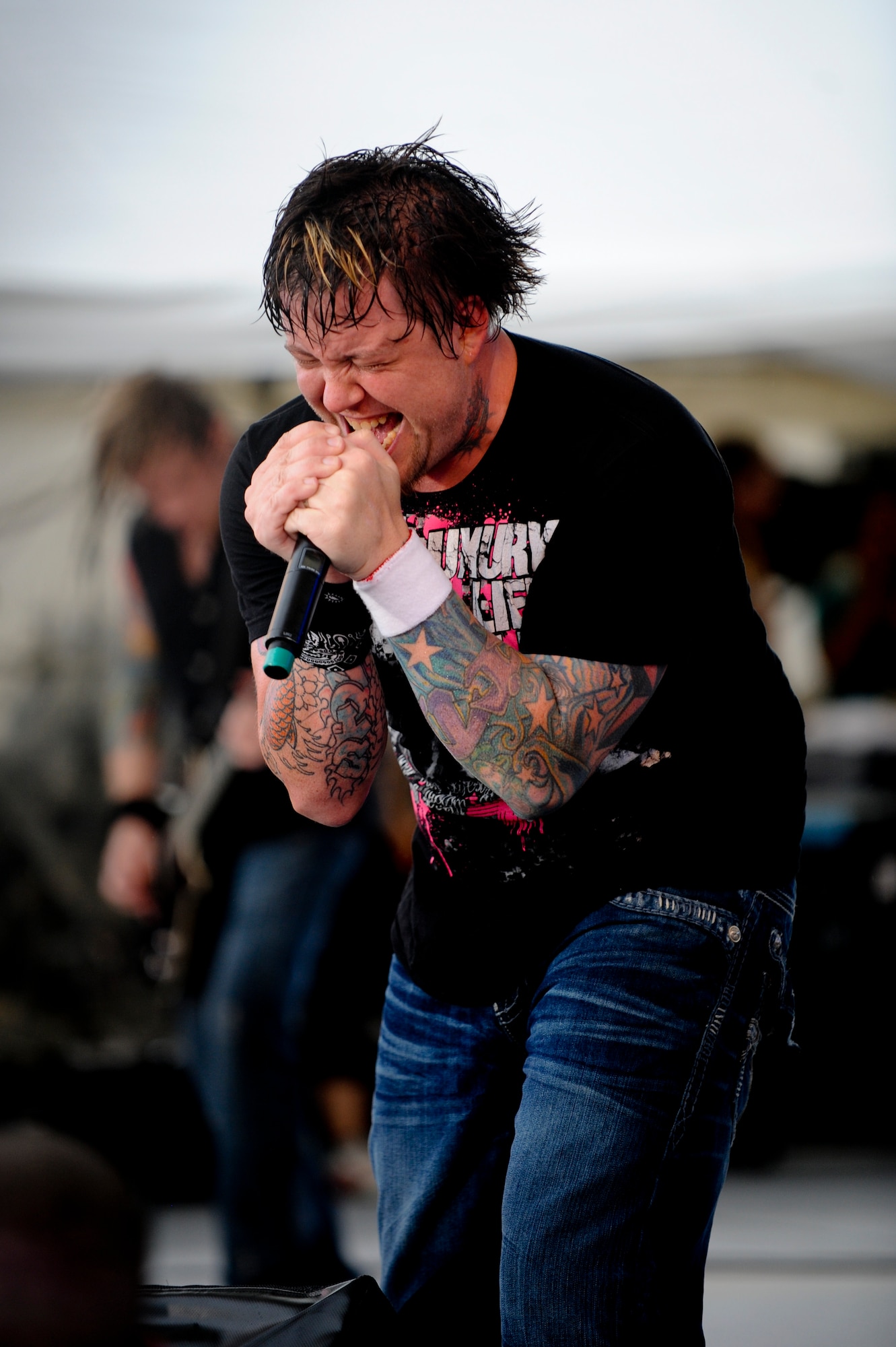 Lead Singer Paul McCoy for 12 Stones screams into a mica phone at AmericaFest July 2. AmericaFest takes place July 1 and 2, and is an event designed to build international relations with the local Okinawan community. (U.S.  Air Force Photo/Staff Sgt. Jonathan Steffen)