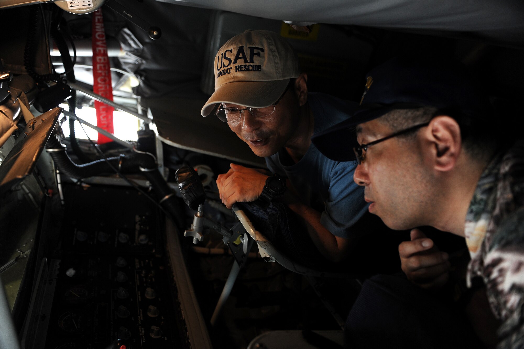 Mr. Yoshimi Takahashi (left) and Mr. Seiichi Takahashi (right), spectators from Tokyo, explore the boom pod of a KC-135 Stratotanker during AmericaFest 2011 at Kadena Air Base, July 2. AmericaFest was an event that opened to the local community in celebration of Independence Day.  Static Japan and U.S. aircraft, food, games, and live entertainment were some of the attractions during the two-day event. (U.S. Air Force photo/Junko Kinjo)