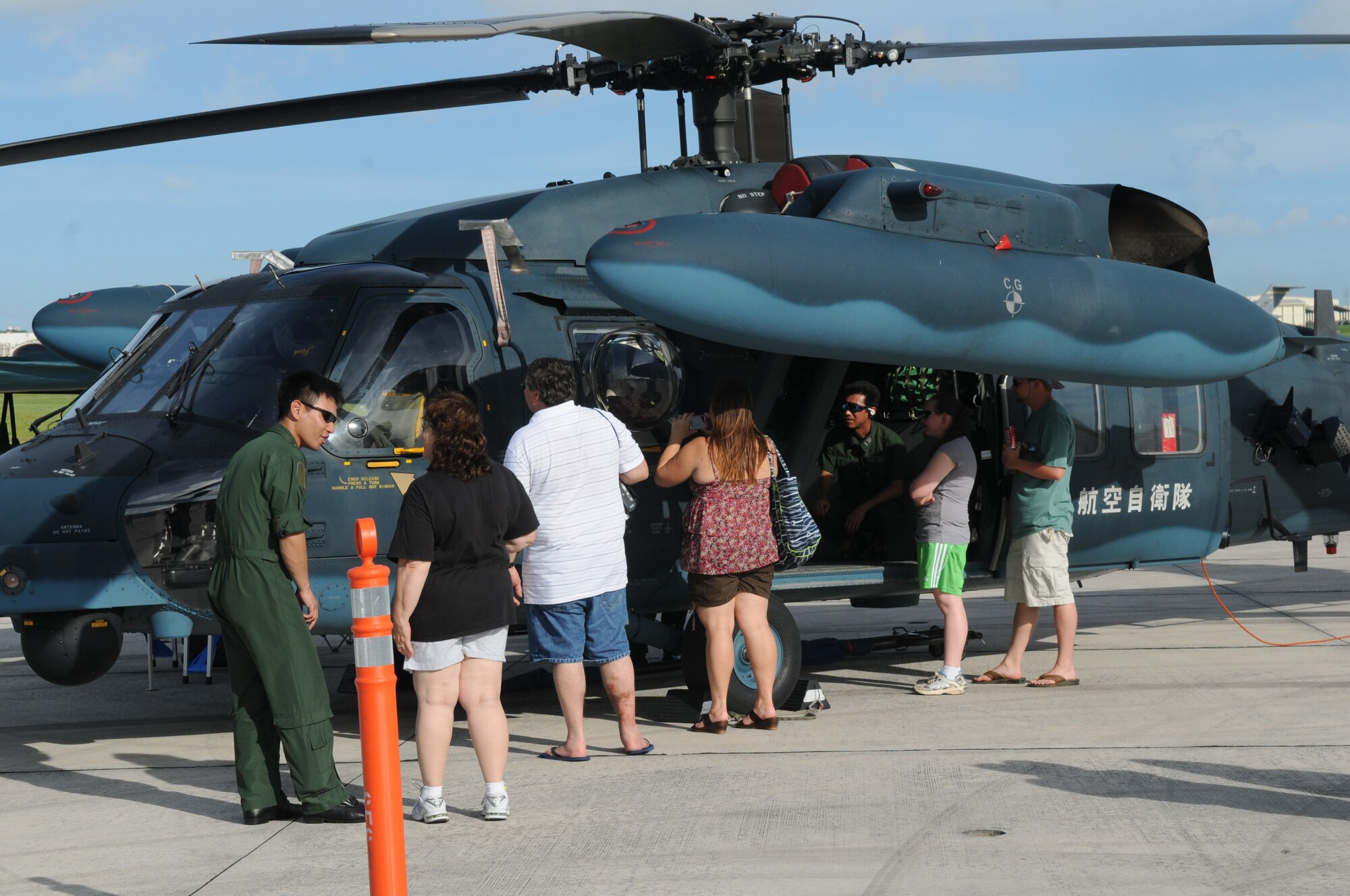 AmericaFest participants interact with Japan Air Self Defense Force UH-60J pilots from Naha, Japan, July 1 during AmericaFest at Kadena Air Base, Japan. AmericaFest took place on the Kadena flight line July 1 and 2. (U.S. Air Force photo/Staff Sgt. Amanda Savannah)