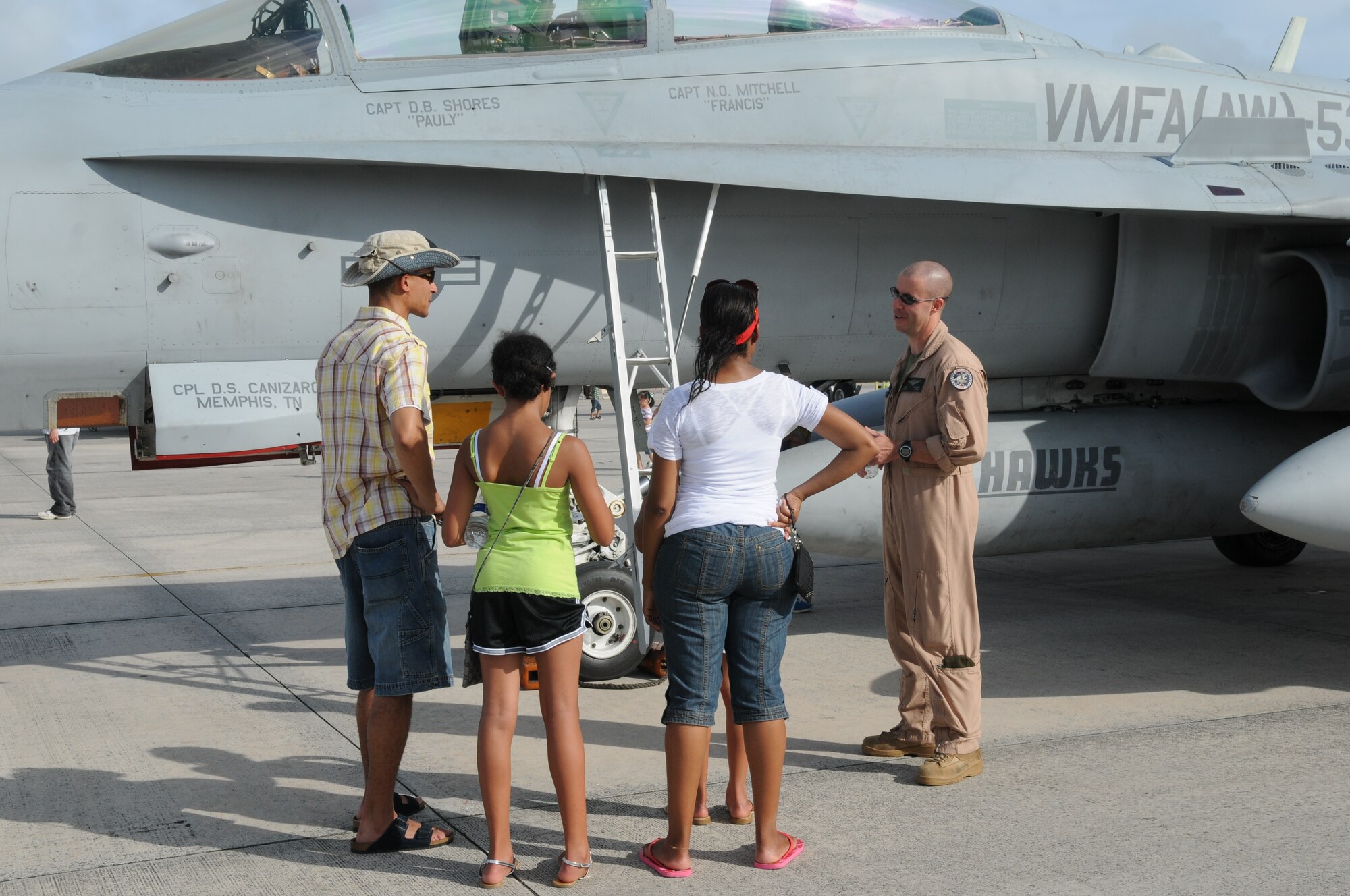 Marine Capt. Douglas Shores, Marine All Weather Fighter Attack Squadron 533 FA-18D pilot from Iwakuni, Japan, talks to AmericaFest participants July 1 during AmericaFest at Kadena Air Base, Japan. AmericaFest took place on the Kadena flight line July 1 and 2. (U.S. Air Force photo/Staff Sgt. Amanda Savannah)