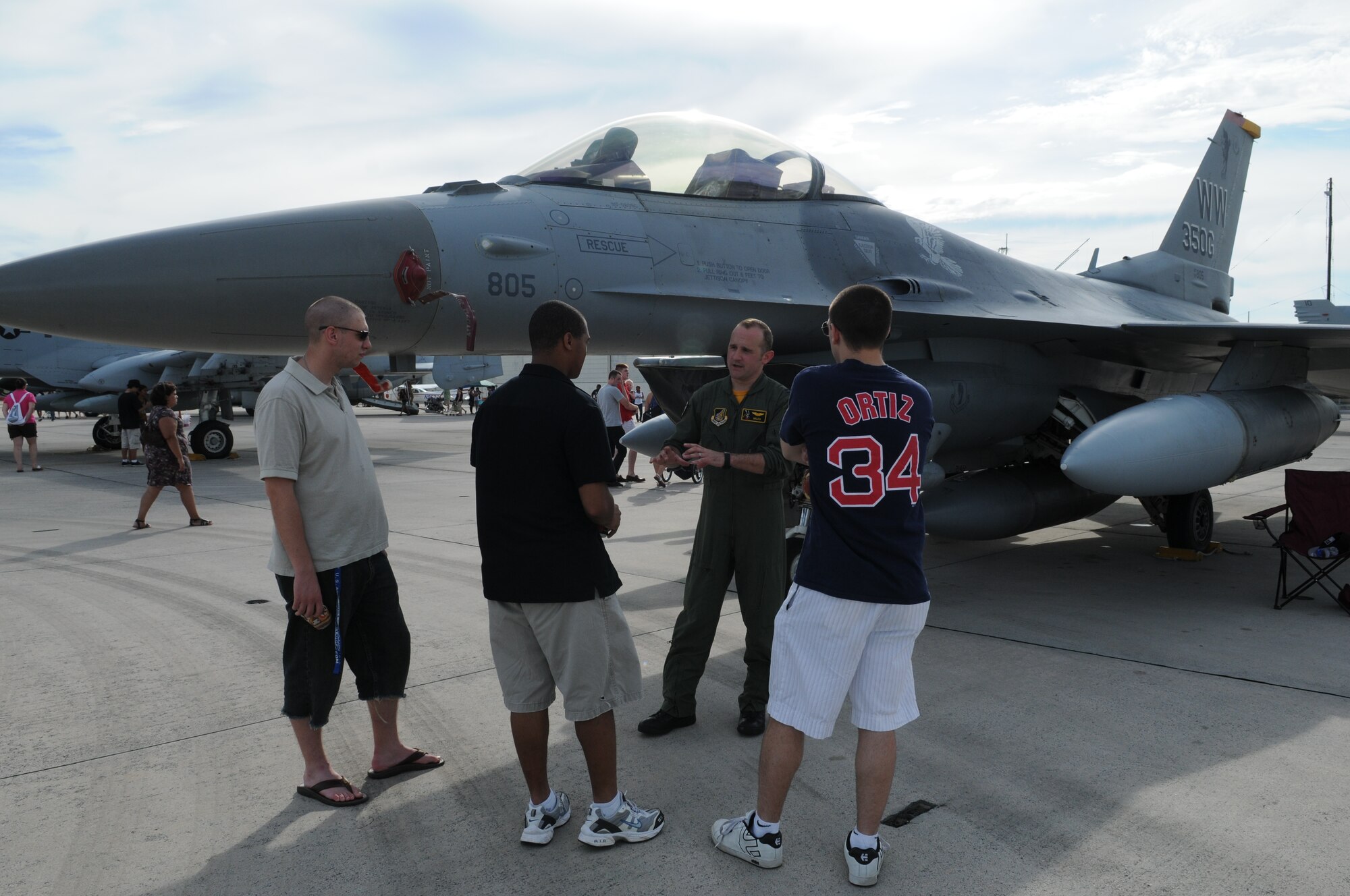 Capt. Nick Edwards, 14th Fighter Squadron F-16 pilot from Misawa Air Base, Japan, talks with AmericaFest participants July 1 during AmericaFest at Kadena Air Base, Japan. AmericaFest took place on the Kadena flight line July 1 and 2. (U.S. Air Force photo/Staff Sgt. Amanda Savannah)