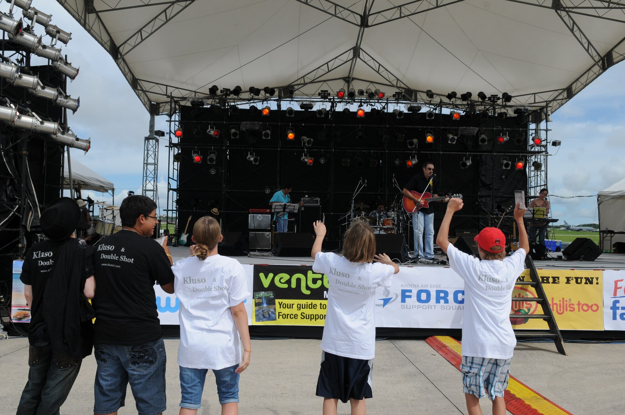 Young AmericaFest participants listen to the band Kluso play July 1 during AmericaFest at Kadena Air Base, Japan. AmericaFest took place on the Kadena flight line July 1 and 2. (U.S. Air Force photo/Staff Sgt. Amanda Savannah)