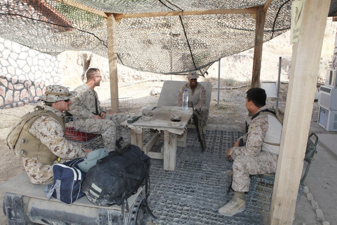 FORWARD OPERATING BASE ZEEBURGEE, Helmand province, Afghanistan— The Marines of the Kajaki Civil Affairs Team share a laugh prior to leaving for a mission. The CAT, out of Washington, D.C., and attached to Echo Battery, 2nd Battalion, 12th Marine Regiment, arrived in Afghanistan in late May to help encourage peace and stability through key leader engagements and development projects in the Kajaki district. ::r::::n::