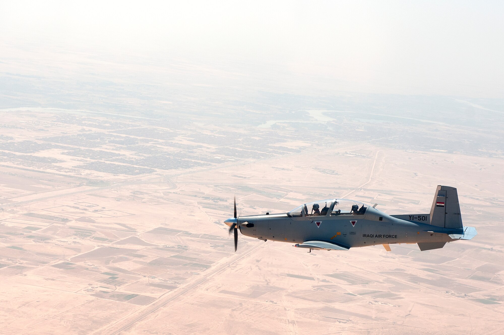 Lt. Col. Theodore Lane, 52nd Expeditionary Flying Training Squadron, instructor pilot, instructs an Iraqi student pilot during a morning sortie over Combat Operation Base Speicher, Tikrit, Iraq on June 29, 2011. This training portion is devoted to graduating Iraqi instructor pilots to achieve the foundation to self sustain Iraqi air power.The primary aircraft for training is the T-6 Texan. (U.S. Air Force photo by Staff Sgt. Jose Rodriguez/Released)