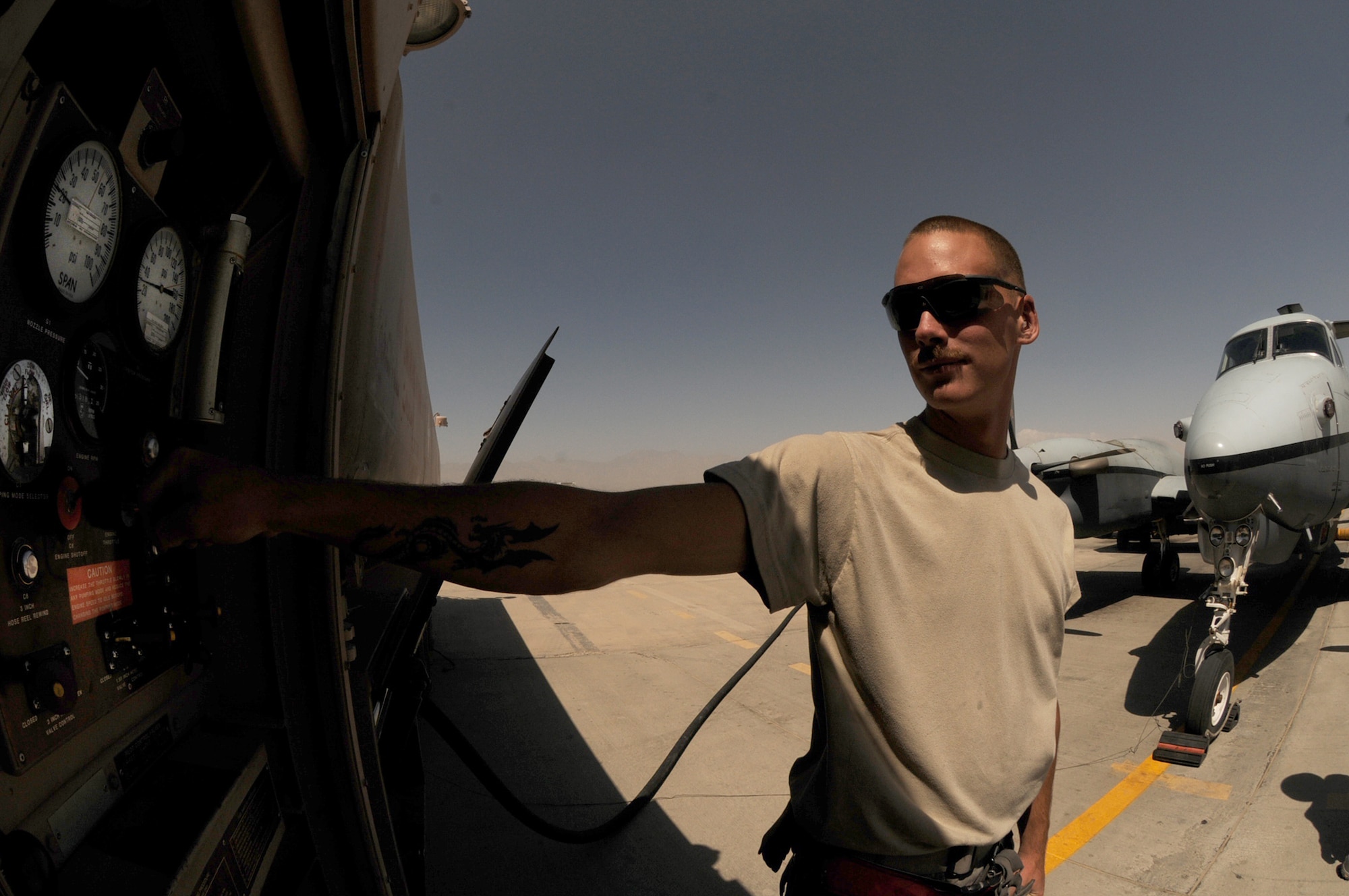 BAGRAM AIRFIELD, Afghanistan -- Airman 1st Class Kailyne Jones,  455th Expeditionary Logistics Readiness Squadron, fuels distribution operator,  fuels a MC-12 Liberty aircraft here July 2. Airman Jones arrived here in February and rapidly established himself as a top performer, helping to safely issue 48 million gallons of fuel to more than 15,000 coalition aircraft. The hard-charging Airman has set numerous fuels records during his time here. To date, he has personally pumped more than 3 million gallons of fuel on more than 2,000 fuel runs, with an average response time of 10 minutes. (U.S. Air Force photo by Senior Airman Krista Rose.)