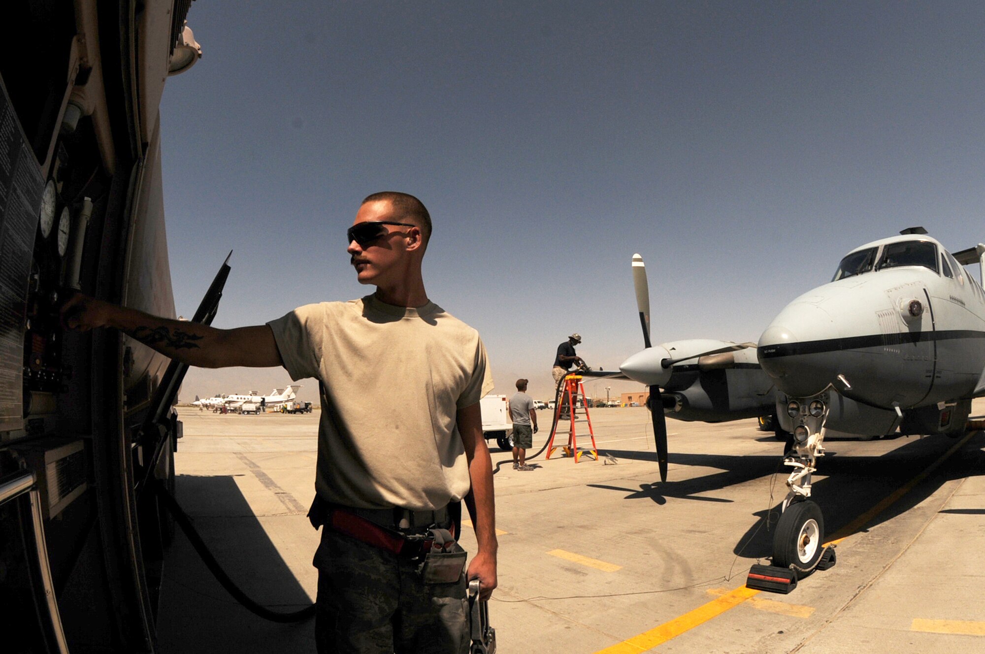 BAGRAM AIRFIELD, Afghanistan -- Airman 1st Class Kailyne Jones,  455th Expeditionary Logistics Readiness Squadron, fuels distribution operator,  fuels a MC-12 Liberty aircraft here July 2. Airman Jones arrived here in February and rapidly established himself as a top performer, helping to safely issue 48 million gallons of fuel to more than 15,000 coalition aircraft. The hard-charging Airman has set numerous fuels records during his time here. To date, he has personally pumped more than 3 million gallons of fuel on more than 2,000 fuel runs, with an average response time of 10 minutes. (U.S. Air Force photo by Senior Airman Krista Rose.)