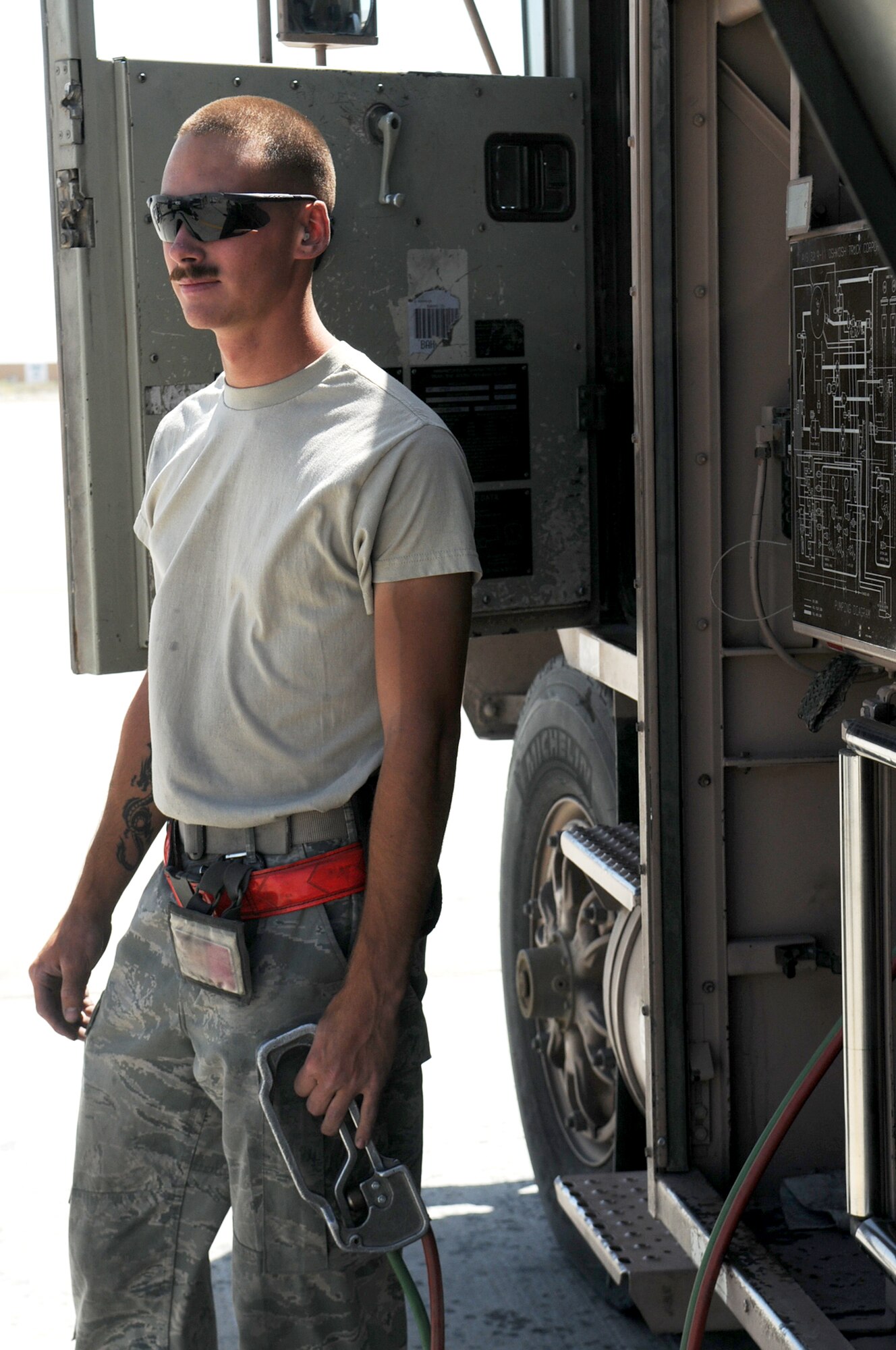 BAGRAM AIRFIELD, Afghanistan -- Airman 1st Class Kailyne Jones,  455th Expeditionary Logistics Readiness Squadron, fuels distribution operator,  fuels a MC-12 Liberty aircraft here July 2. Airman Jones arrived here in February and rapidly established himself as a top performer, helping to safely issue 48 million gallons of fuel to more than 15,000 coalition aircraft. The hard-charging Airman has set numerous fuels records during his time here. To date, he has personally pumped more than 3 million gallons of fuel on more than 2,000 fuel runs, with an average response time of 10 minutes. (U.S. Air Force photo by Senior Airman Krista Rose.)