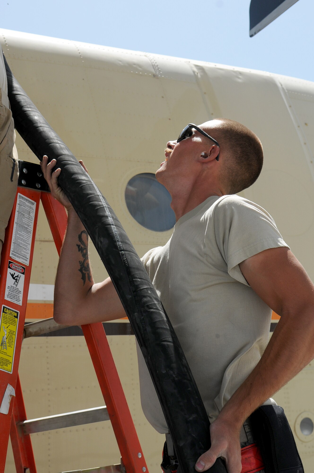 BAGRAM AIRFIELD, Afghanistan -- Airman 1st Class Kailyne Jones,  455th Expeditionary Logistics Readiness Squadron, fuels distribution operator,  fuels a MC-12 Liberty aircraft here July 2. Airman Jones arrived here in February and rapidly established himself as a top performer, helping to safely issue 48 million gallons of fuel to more than 15,000 coalition aircraft. The hard-charging Airman has set numerous fuels records during his time here. To date, he has personally pumped more than 3 million gallons of fuel on more than 2,000 fuel runs, with an average response time of 10 minutes. (U.S. Air Force photo by Senior Airman Krista Rose.)