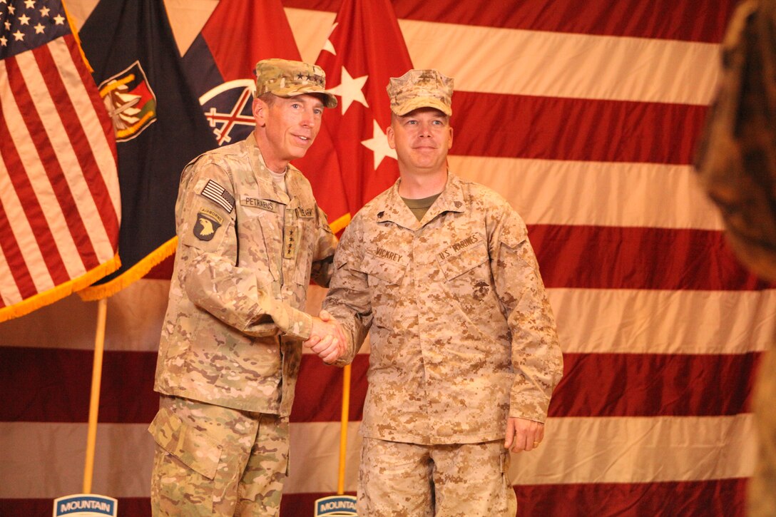 Gen. David Petraeus, left, U.S. Forces Afghanistan and NATO International Security Assistance Force commander, shakes hands with Sgt. James Vickrey, Marine Attack Squadron 513’s career planner, during an Independence Day ceremony at Kandahar Airfield, Afghanistan, July 4. “Being in Afghanistan on the birthday of our nation is one of the most rewarding moments of my life,” said Vickrey. “While it is not easy to be away from my loved ones on this day, I know that in some small part that what I am doing on this is making this world a better place to live.” Vickrey and his squadron are deployed from Marine Corps Air Station Yuma, Ariz., to Kandahar.
