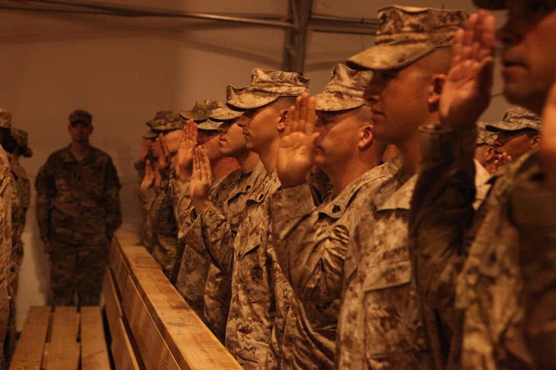 U.S. Marines with Marine Attack Squadron 513 raise their hands during an Independence Day ceremony at Kandahar Airfield, Afghanistan, July 4. The ceremony, “Operation Red, White and True,” offered U.S. troops in Kandahar the opportunity to reenlist and reaffirm their oaths of service. “America can never thank you enough,” said Petraeus. “I think it’s important to note that unlike the soldiers of my generation, each of you joined knowing there was a possibility you’d be facing hostile combat activity.” The Marine attack squadron is deployed from Marine Corps Air Station Yuma, Ariz., to Kandahar.
