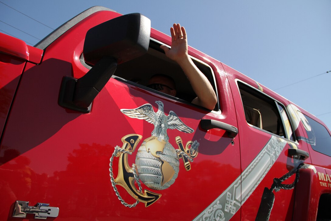 Staff Sgt. Timothy Anderson, 31, from Fall Creek, Wis., waves to residents while driving a branded H3 in the Forest Lake Fourth of July Annual Parade. The parade is part of the city's annual Independence Day celebration and dates to 1924 when residents observed the holiday with numerous events and family activities. Anderson is a recruiter out of the Coon Rapids, Minn., office. For additional imagery from the event, visit www.facebook.com/rstwincities.