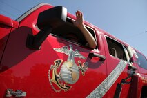 Staff Sgt. Timothy Anderson, 31, from Fall Creek, Wis., waves to residents while driving a branded H3 in the Forest Lake Fourth of July Annual Parade. The parade is part of the city's annual Independence Day celebration and dates to 1924 when residents observed the holiday with numerous events and family activities. Anderson is a recruiter out of the Coon Rapids, Minn., office. For additional imagery from the event, visit www.facebook.com/rstwincities.