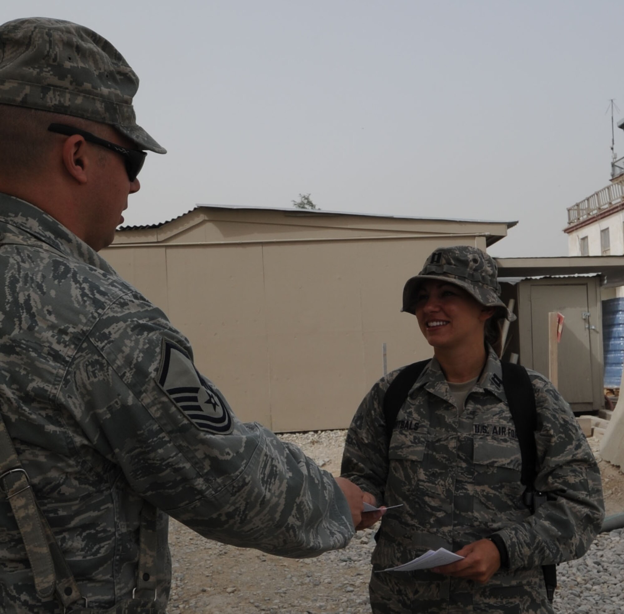 BAGRAM AIRFIELD, Afghanistan -- Capt. Sara Ortbals, Sexual Assault Response Coordinator, provides sexual assault prevention information to a Bagram community member. Captain Ortbals supports 80 forward operating bases in northeast Afghanistan June 26. (U.S. Air Force photo by Master Sgt. Mary Davis)