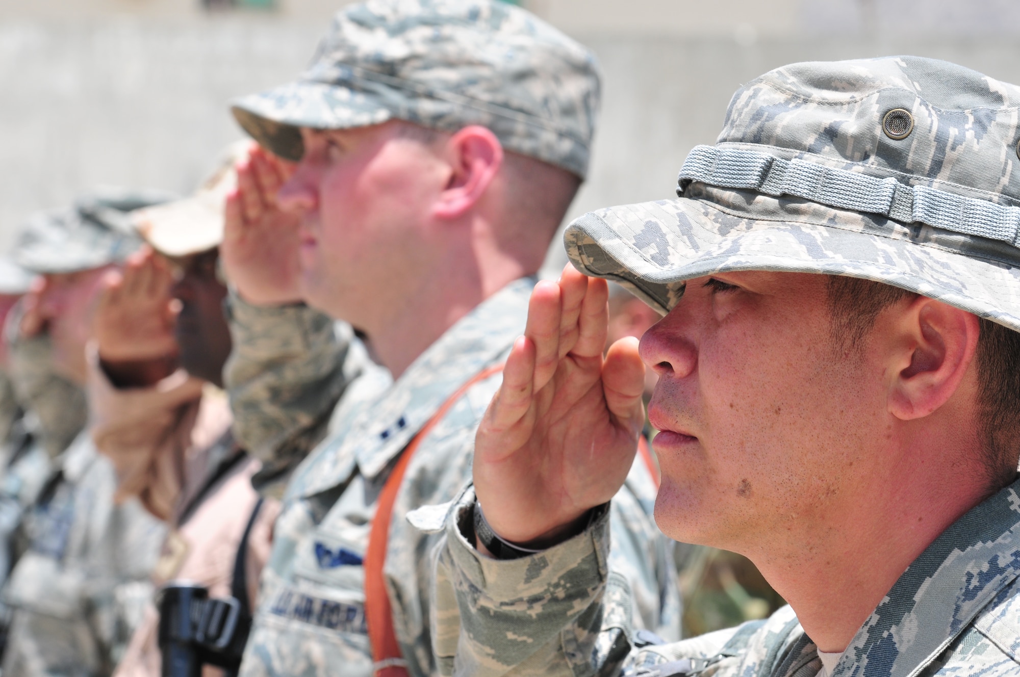 KABUL, Afghanistan -- Airmen of the 438th Air Expeditionary Wing, stand at attention during a retreat ceremony July 4, 2011. The deployed Airmen are responsible for setting the conditions for a professional, fully independent and operationally-capable Afghan Air Force.  (U.S. Air Force photo by Tech. Sgt. Brian E. Christiansen)