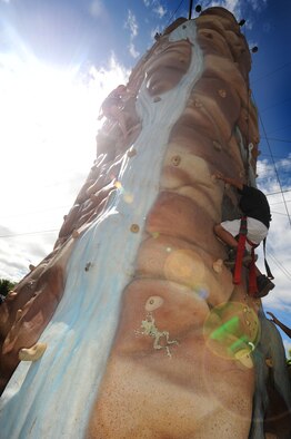 Children scale a rock climbing wall at Hickam Harbor on July 4. The festivities, sponsored by MWR, included bouncy houses,  food vendors and a free concert by the Plain White T's.  Hundreds of families and military members camped at the harbor the night before and stayed to enjoy the brilliant display of Fourth of July fireworks that evening. (U.S. Air Force photo/Senior Airman Lauren Main)