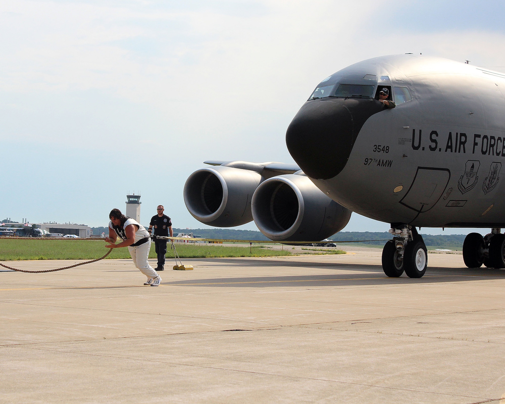 Battle Creek, Mich. -- Strongman Mark Kirsch pulls a KC-135 Stratotanker from the 54th Air Refueling Squadron, Altus Air Force Base, weighing 140,000 pounds at the Battle Creek Field of Flight and Balloon Festival, Battle Creek, Mich. July 1, 2011. The KC-135 was the first Air Force plane to ever be pulled by a strongman. (Courtesy photo by the Battle Creek Enquirer)