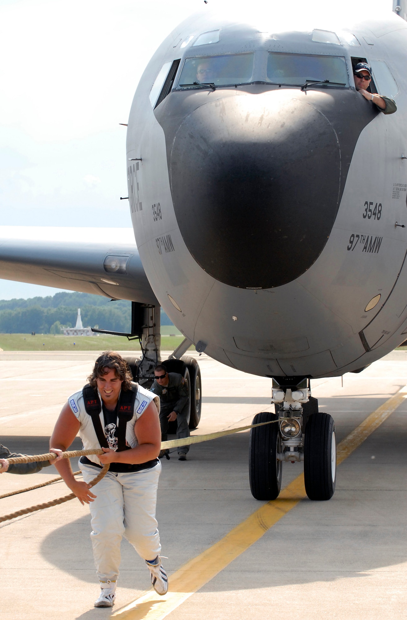 Battle Creek, Mich. -- Strongman Mark Kirsch pulls a KC-135 Stratotanker from the 54th Air Refueling Squadron, Altus Air Force Base, weighing 140,000 pounds at the Battle Creek Field of Flight and Balloon Festival, Battle Creek, Mich. July 1, 2011. The KC-135 was the first Air Force plane to ever be pulled by a strongman. (Courtesy photo by the Battle Creek Enquirer)