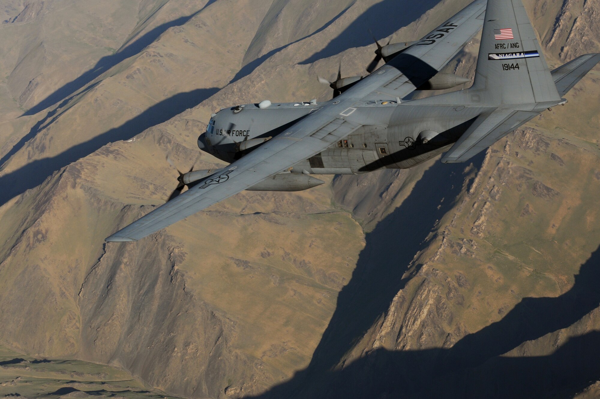 A C-130 Hercules aircrew from the New York Air National Guard’s 107th Airlift Wing flies over mountainous Afghan terrain June 22, 2011, on the way to delivering much-needed supplies to a forward operating base in Oruzgan Province. (U.S. Air Force photo/Senior Airman Krista Rose)