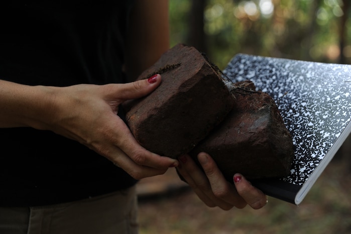Kristina Lanphear carries bricks she will use for research at Joint Base Charleston - Weapons Station June 21. Brick making was active on the land that now belongs to the Weapons Station for more than 200 years between the 1600's and 1800's. (U.S. Air Force photo/ Staff Sgt. Nicole Mickle)