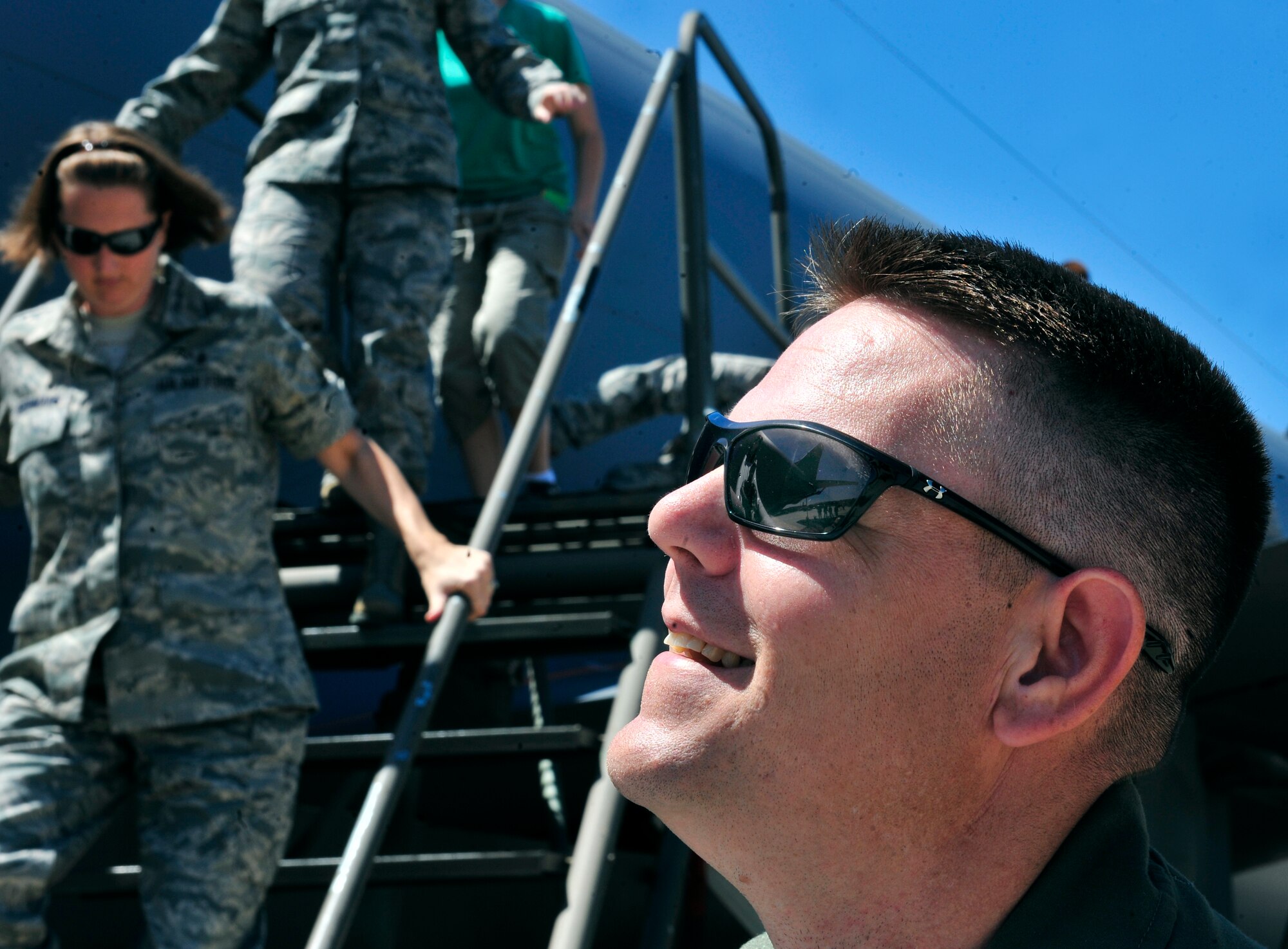 Master Sgt. Shane Haney, Air Mobility Command standardization and evaluations, secures an aft slide as passengers evacuate a KC-135, during an egress scenario on Scott AFB June 28, 2011. The AMC directed test was used to determine the quantity of passengers one passenger monitor can safely egress, or evacuate, from an aircraft in 90 seconds. (U.S. Air Force photo/ Staff Sgt. Stephenie Wade)