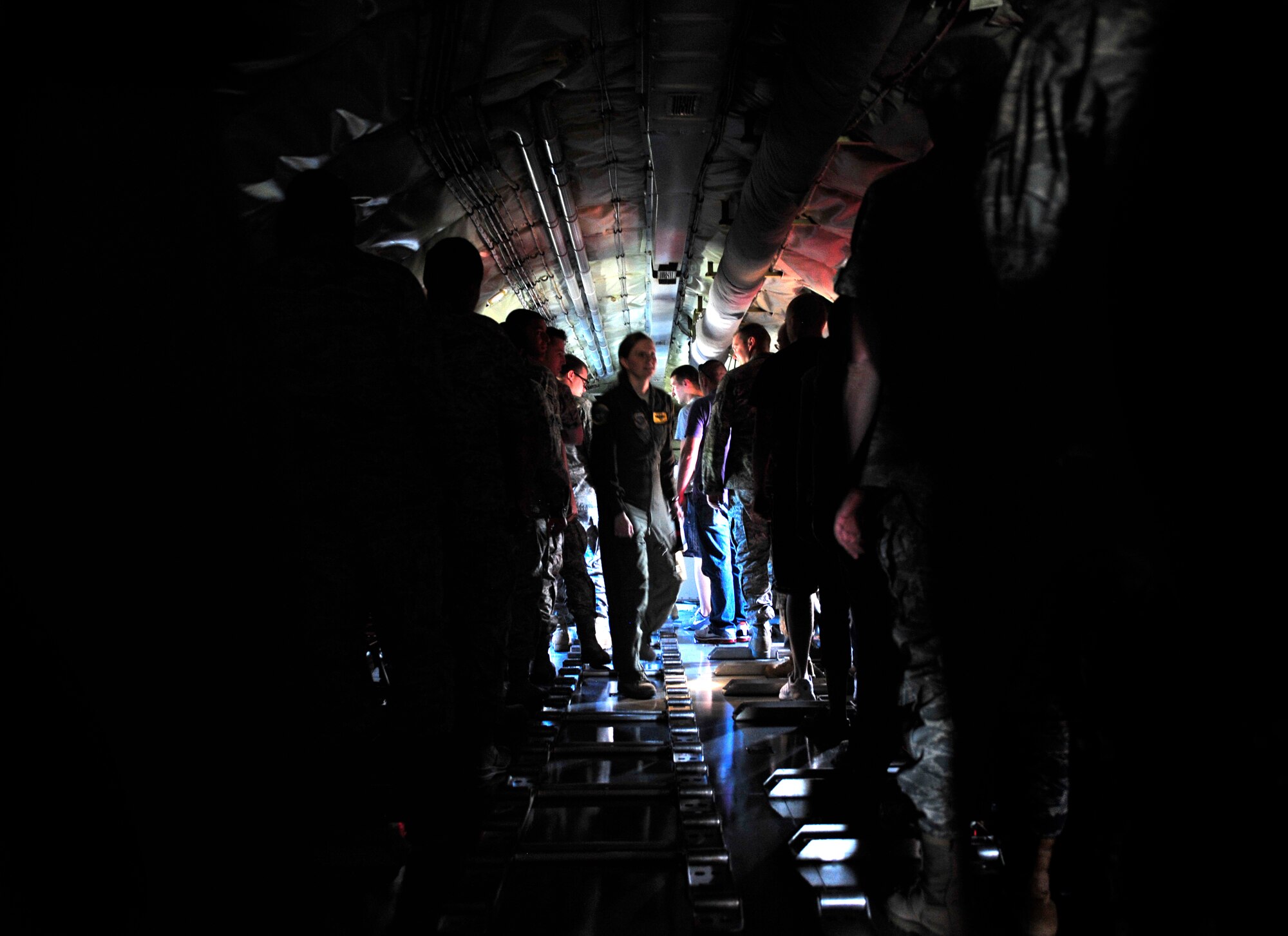 Tech. Sgt. Justine Pescetello-Parr gives evacuation directions to passengers on a KC-135 during an egress scenario on Scott AFB June 28, 2011. Sergeant Pescetello-Parr is the training flight NCOIC of the 906th Air Refueling Squadron. The AMC directed test was used to determine the quantity of passengers one passenger monitor can safely egress, or evacuate, from an aircraft in 90 seconds. (U.S. Air Force photo/ Staff Sgt. Stephenie Wade)