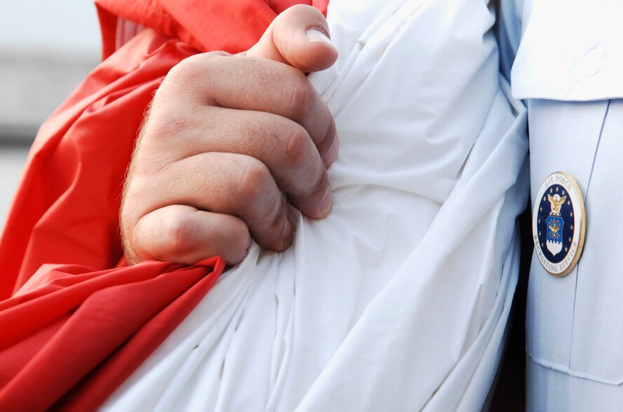 U.S. Air Force Senior Master Sgt. Shawn Eikenberry, 336th Recruiting Squadron first sergeant, clutches the American flag after helping display it July 2, 2011, at the Coke Zero 400 in Daytona Beach, Fla. The 336th RCS enlisted the help of about 120 Airmen and cadets to hold the flag, which was the center of attention during the national anthem. (U.S. Air Force photo by Airman 1st Class Brigitte N. Brantley/Released)