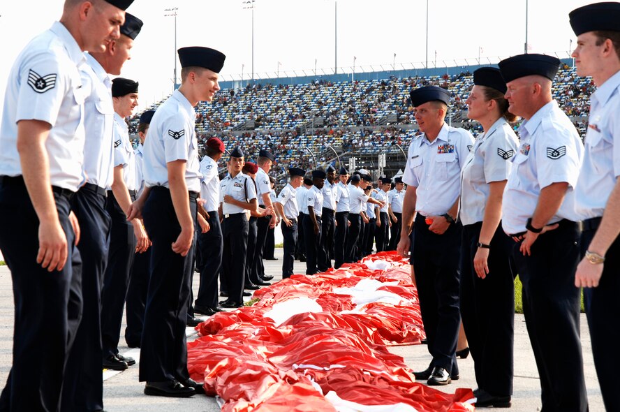 Airmen from Moody Air Force Base, Ga., line up with other Airmen and Air Force JROTC cadets July 2, 2011, while preparing to hold a football field-sized flag during the national anthem at the Coke Zero 400 in Daytona Beach, Fla. The race was viewed by a live crowd of 115,000 and seven million more on TV and online. (U.S. Air Force photo by Airman 1st Class Brigitte N. Brantley/Released)
