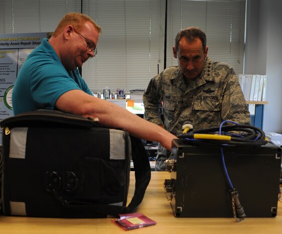 Steven Compton explains maintenance procedures to Gen. Raymond E. Johns Jr. during a tour of the Priority Asset Repair Section at Joint Base Charleston- Air Base June 29. Johns toured JB CHS- AB and Weapons Station during his two day visit. Johns is the Air Mobility Command commander and Compton is with the 437th Aircraft Maintenance Squadron. (U.S. Air Force photo/ Staff Sgt. Nicole Mickle)