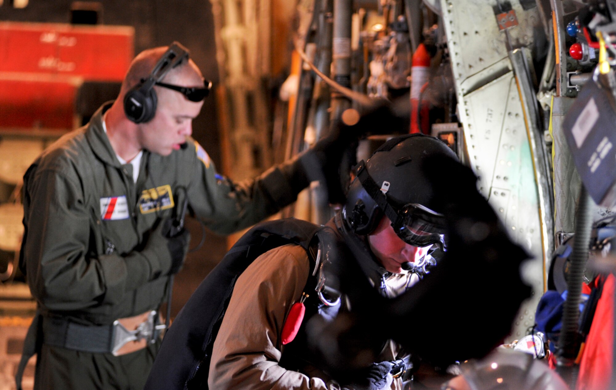 JOINT BASE ELMENDORF-RICHARDSON, Alaska ??? An Alaska Air National Guard, 212th Rescue Squadron pararescuemen stares out the window of a U.S. Coast Guard C-130 Hercules waiting to reach the drop zone during a training mission June 23. (U.S. Air Force photo/ Airman 1st Class Jack Sanders)