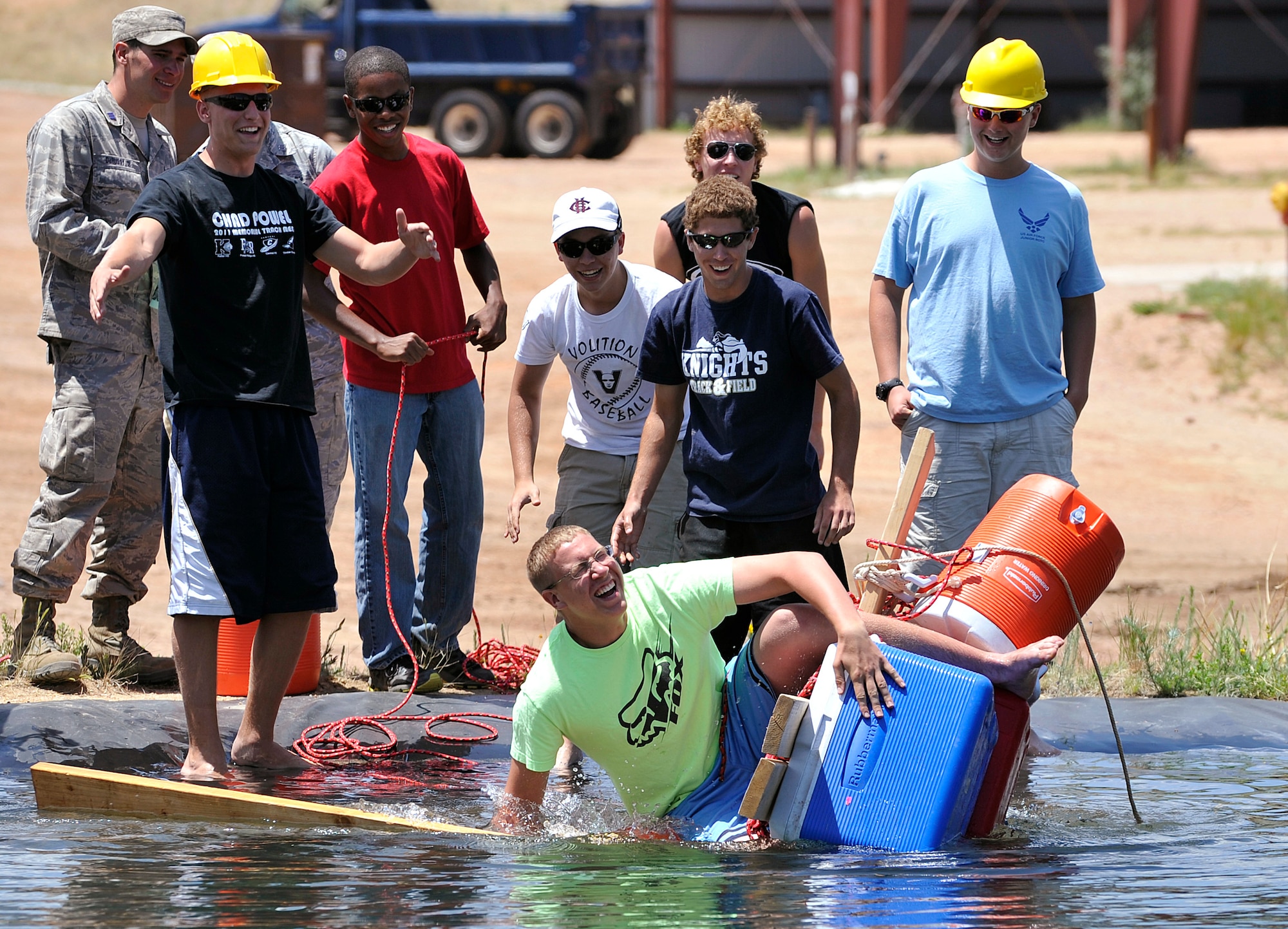 Robert Lansing loses his balance on a makeshift raft as other members of his flight watch during a Society of American Military Engineers camp at the Air Force Academy June 25, 2011. SAME camps introduce high schoolers to engineering principles using a "build first, design later" strategy. Robert is a native of Menands, N.Y. (U.S. Air Force photo/Bill Evans)