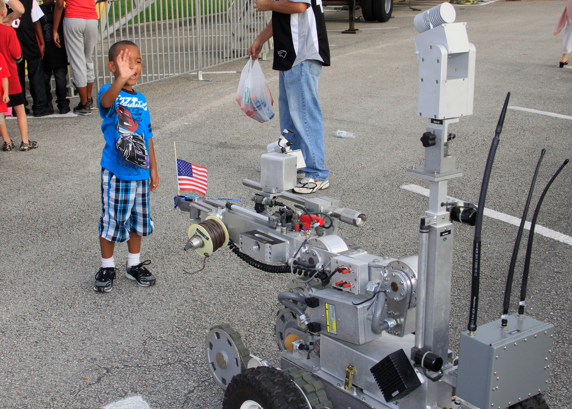 HOMESTEAD AIR RESERVE BASE, Fla. -- A young guest waves to the Explosive Ordnance Disposal Robot at Homestead ARB during the second annual 4th of July celebration. More than 1500 people attended the event, six times the amount from the previous year. People of all ages were treated to free food and souvenirs from sponsors as well as games, music and a spectacular fireworks display.(US Air Force photo/Mr. Ian Carrier)
