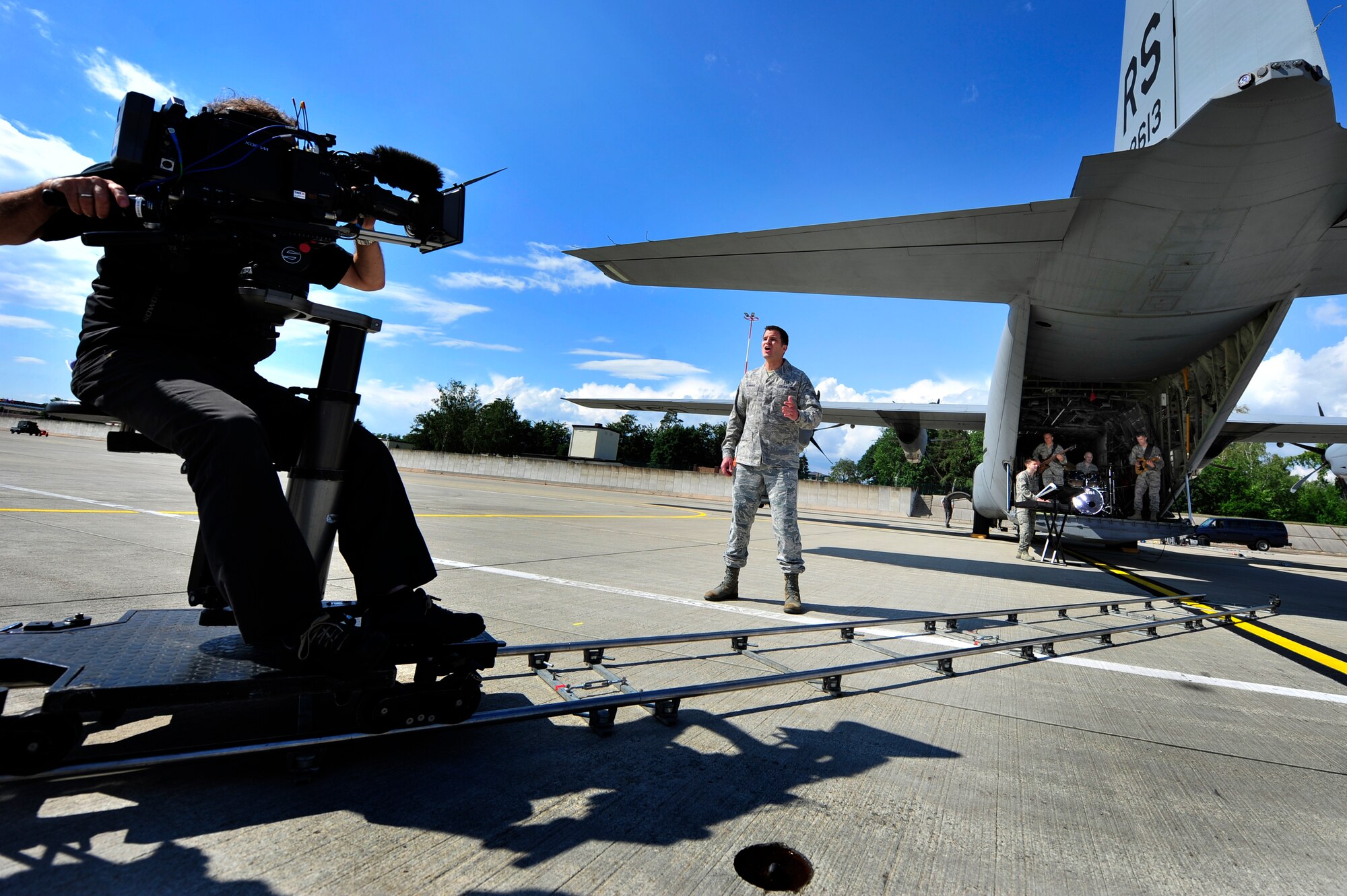 Lead vocalist, Staff Sgt. Craig Bowman, belts out the lyrics to "Don’t Stop Believing,” by the classic rock group Journey. Bowman is the front man for the U.S. Air Forces in Europe rock band, Touch 'n' Go.  The band performed for German television network Südwestrundfunk on the flightline at Ramstein Air Base Germany, July 2, 2011. (U.S. Air Force Photo by Tech. Sgt. Chenzira Mallory)