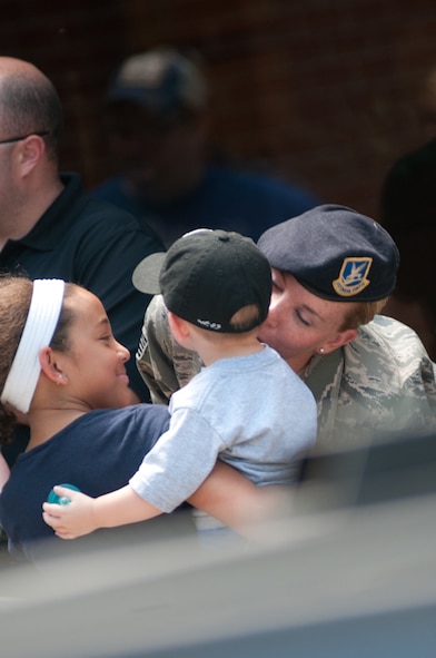 Members of the 139th Airlift Wing, Security Forces Squadron, Missouri Air National Guard, say goodbye to family and friends on July 2, 2011 at Rosecrans Memorial Airport. The Airmen are deploying for six months overseas. (U.S. Air Force photo by Senior Airman Sheldon Thompson/RELEASED)