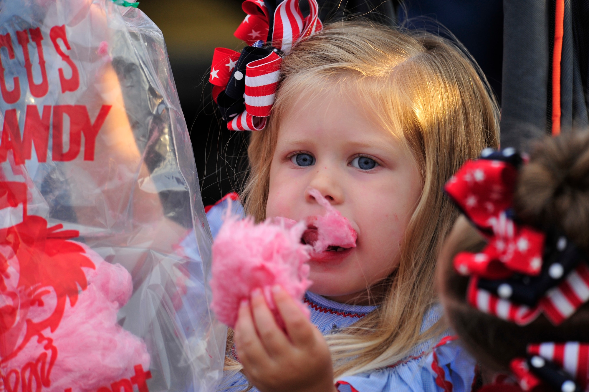 Abigail Bertolucci, 3, daughter of U.S. Air Force Tech. Sgt. Brian Bertolucci, 86th Operations Support Squadron, air traffic controller, eats cotton candy during the Rockin' 2nd Independence Day event, Kapaun Air Station Germany, July 2, 2011.  The celebration was hosted by the 86th Force Support Squadron and included musical entertainment, children's activities, carnival rides, food specialties, prizes and a fireworks display.  (U.S. Air Force Photo by Tech. Sgt. Chenzira Mallory)