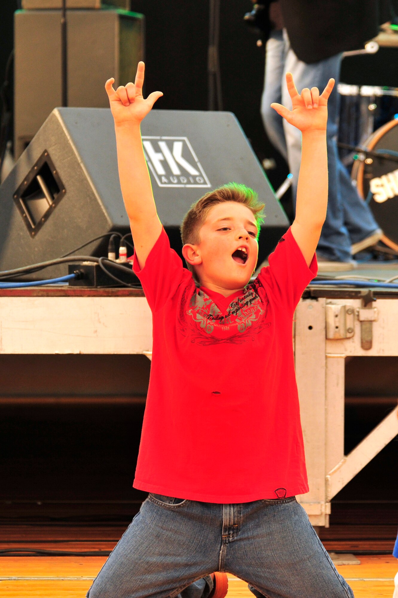 Tyler Colabine, 8, son of Master Sgt. Jason Colabine, 83rd Network Operations Squadron Detachment 4, sings and dances as the band Sheerocks performs during the Rockin' 2nd Independence Day event, Kapaun Air Station Germany, July 2, 2011. The celebration was hosted by the 86th Force Support Squadron and included musical entertainment, children's activities, carnival rides, food specialties, prizes and a fireworks display.  (U.S. Air Force Photo by Tech. Sgt. Chenzira Mallory)