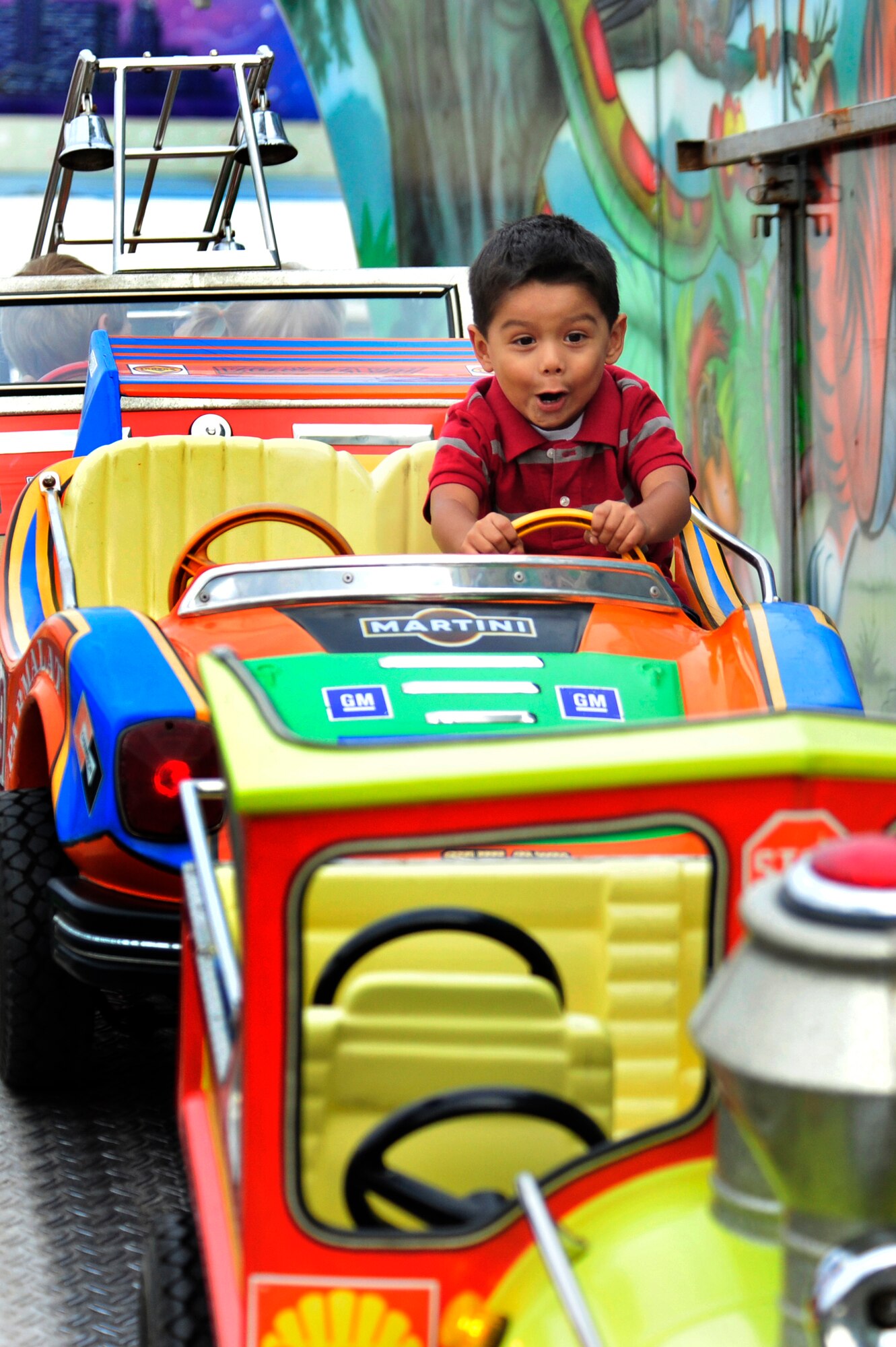 Aston Trejo, 2, son of U.S. Army 1st Lt. David Trejo, 357 Air Missile Defense Detachment, enjoys a ride on the rollercoaster during the Rockin' 2nd Independence Day event, Kapaun Air Station Germany, July 2, 2011. The celebration was hosted by the 86th Force Support Squadron and included musical entertainment, children's activities, carnival rides, food specialties, prizes and a fireworks display.  (U.S. Air Force Photo by Tech. Sgt. Chenzira Mallory)