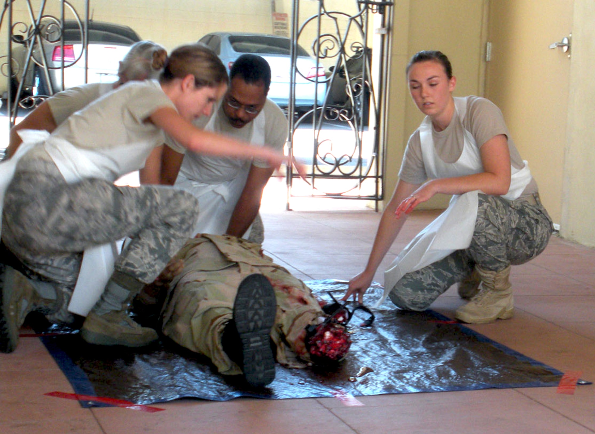 Capt. Shirley Roberts (left, background), Staff Sgt. Tiara Glover (left, foreground), Master Sgt. Philip Baker (center) and Airman Erica Koontz perform training on a mannequin patient during annual training at the Scottsdale, Ariz., Healthcare Military Training Center June 21, 2011.  (Photo by Keith Jones/110621-F-SA253-001)
