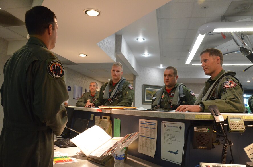 Maj. Gen. David S. Baldwin, the Adjutant General of the California National Guard, along with Lt. Col. Dodd Wamberg, 194th Fighter Squadron commander and Maj. Christopher Corliss , a pilot with the 194th Fighter Squadron recive their step brief from Maj. Donald Charlton before the generals F-16 familiarization flight July 1, 2011.The familiarization flight took place with the 144th Fighter Wing's 194th Fighter Squadron in Fresno Calif.(U.S. Air Force photo by Staff Sgt. Michael Barden)
