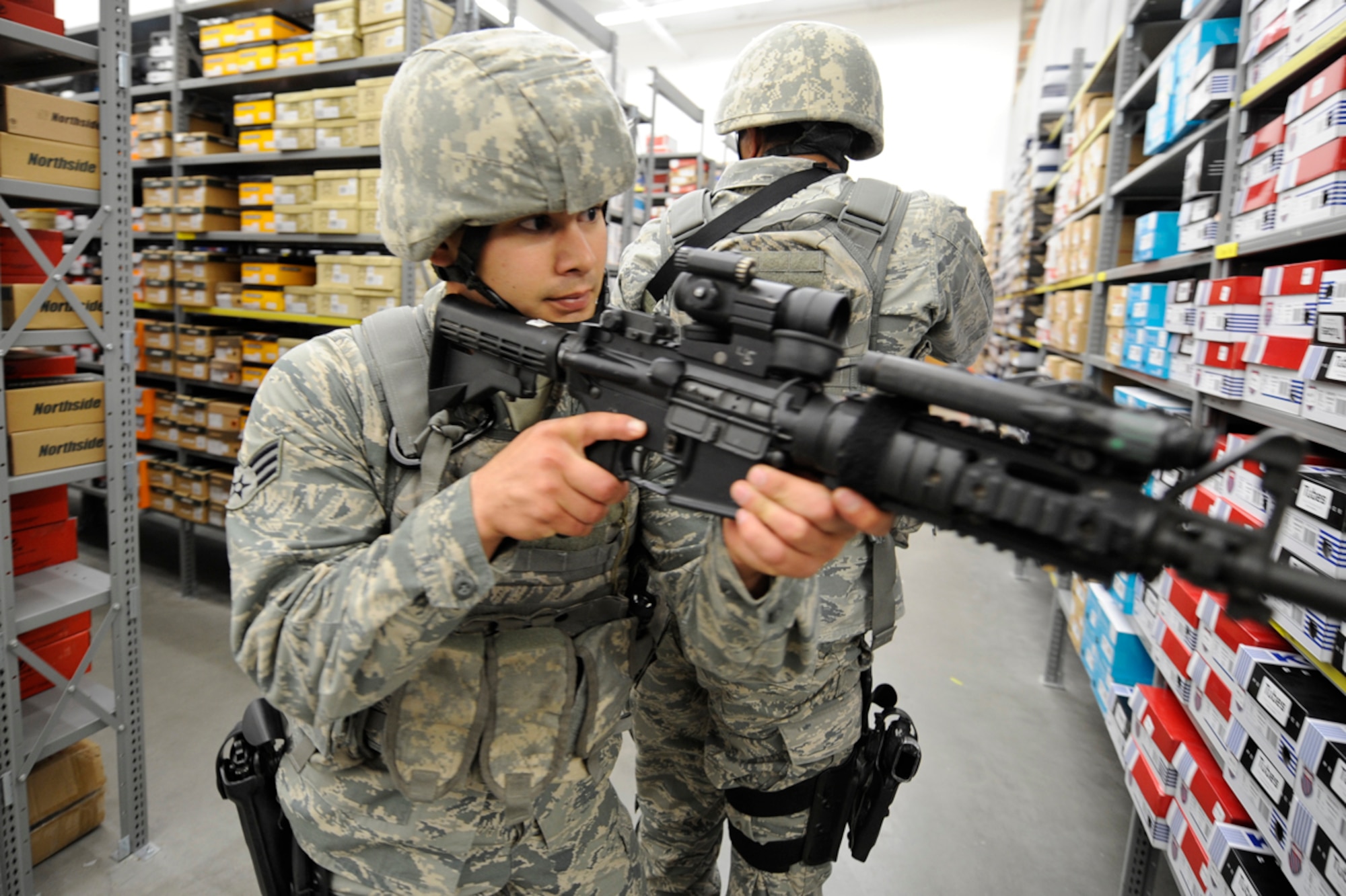 Senior Airman Kevin Freeman, sweeps a warehouse, June 24, during an active-shooter scenario. (U.S. Air Force photo/Steve White)