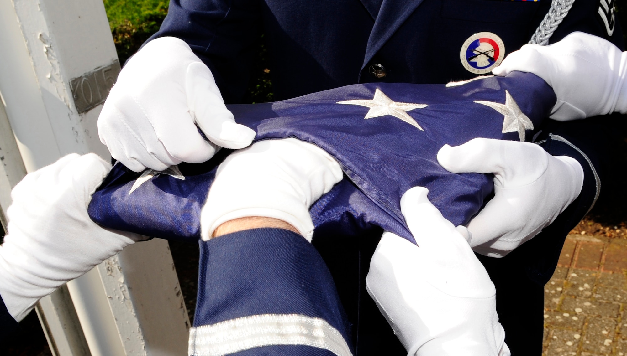 RAF MILDENHALL, England – The American flag is folded during retreat here July 1, 2011. The flag is lowered at the last note of retreat, before being carefully folded into the shape of a tri-cornered hat, emblematic of the hats worn by colonial soldiers during the American Revolutionary War. (U.S. Air Force photo/Senior Airman Ethan Morgan)