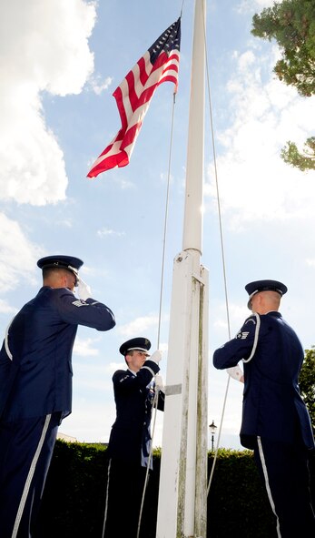 RAF MILDENHALL, England – Staff Sgt. Emmanuel Santillan, Airman 1st Class Taylor Mogford and Senior Airman Zachary Kruly, all RAF Mildenhall Honor Guard, perform flag security detail during retreat here July 1, 2011. Retreat signals the end of the duty day, while also paying respect to the flag. (U.S. Air Force photo/Senior Airman Ethan Morgan