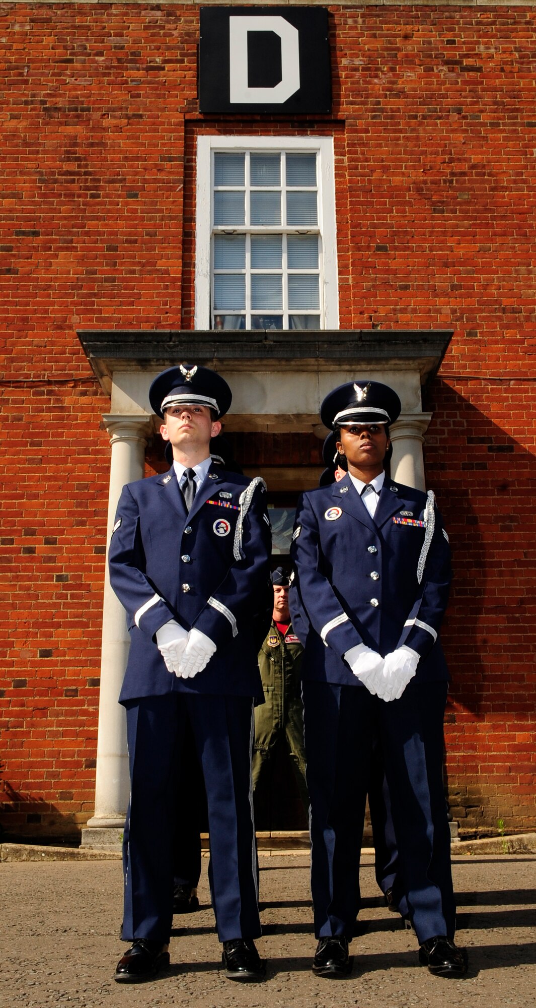 RAF MILDENHALL, England – Airman 1st Class Taylor Mogford and Senior Airman Santianna White, both RAF Mildenhall Honor Guard, stand at parade rest while waiting for the beginning of retreat here July 1, 2011. Retreat was jointly hosted by 100th Operations Group and 100th Air Refueling Wing staff agencies. (U.S. Air Force photo/Senior Airman Ethan Morgan)